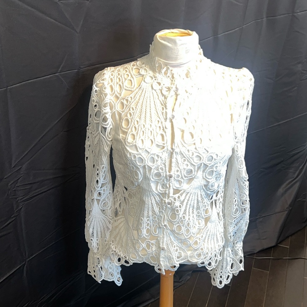 Embrace the elegance of crochet with this stunning HAUTE MONDE lace blouse.